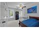 Bedroom features ample natural light, ceiling fan, and closet for storage at 1408 Bridgeport Dr, Raleigh, NC 27615