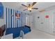 Stylish bedroom featuring blue accents, ceiling fan, and a closet for ample storage at 1408 Bridgeport Dr, Raleigh, NC 27615