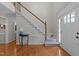 Elegant foyer with hardwood flooring, carpeted stairs, and a view of the front door at 1408 Bridgeport Dr, Raleigh, NC 27615