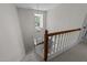 Bright staircase featuring a large window and classic railing design at 1408 Bridgeport Dr, Raleigh, NC 27615