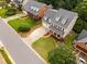 Aerial view of homes with well-manicured lawns, lush landscaping, and long driveways at 1412 Kings Lassiter Way, Raleigh, NC 27614