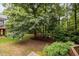 Lush backyard featuring a large tree that provides shade, and green space at 1412 Kings Lassiter Way, Raleigh, NC 27614