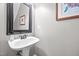 Clean and simple half-bathroom with pedestal sink and framed wall art at 1412 Kings Lassiter Way, Raleigh, NC 27614