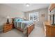 Bedroom featuring neutral walls, carpet, and a wooden bedframe with two bedside tables at 1412 Kings Lassiter Way, Raleigh, NC 27614