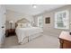 Bedroom with neutral walls, a plush carpet, and a queen bed flanked by matching bedside tables at 1412 Kings Lassiter Way, Raleigh, NC 27614