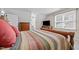 Bedroom featuring neutral walls, carpet, a wooden bedframe, a dresser, and a television at 1412 Kings Lassiter Way, Raleigh, NC 27614