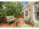 An inviting outdoor space featuring comfortable seating, a table, and lush trees at 1412 Kings Lassiter Way, Raleigh, NC 27614