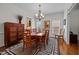 Charming dining room with hardwood floors, an antique buffet, and ornate chandelier at 1412 Kings Lassiter Way, Raleigh, NC 27614