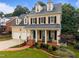 Charming two-story home featuring a welcoming front porch and well-manicured landscaping at 1412 Kings Lassiter Way, Raleigh, NC 27614
