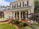 Charming front porch with rocking chairs and landscaped garden at 1412 Kings Lassiter Way, Raleigh, NC 27614
