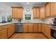 Well-lit kitchen featuring wooden cabinets, stainless steel appliances, and granite countertops at 1412 Kings Lassiter Way, Raleigh, NC 27614