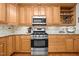 Updated kitchen featuring stainless steel appliances, light wood cabinets, and granite countertops at 1412 Kings Lassiter Way, Raleigh, NC 27614