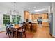 Open-concept kitchen with a breakfast nook featuring modern appliances, and a large window at 1412 Kings Lassiter Way, Raleigh, NC 27614
