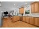 Modern kitchen featuring stainless steel appliances, and hardwood floors with an island at 1412 Kings Lassiter Way, Raleigh, NC 27614
