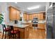Well-lit kitchen with stainless steel appliances, granite countertops, and light wood cabinets at 1412 Kings Lassiter Way, Raleigh, NC 27614