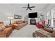 Comfortable living room with a fireplace, TV, and decorative shelves enhancing the space at 1412 Kings Lassiter Way, Raleigh, NC 27614