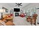 Cozy living room with fireplace, ceiling fan, and large windows offering natural light at 1412 Kings Lassiter Way, Raleigh, NC 27614