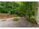 Landscaped backyard featuring stone accents, string lights, and mature trees at 145 Ryan Rd, Pittsboro, NC 27312