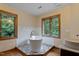 Serene bathroom with freestanding tub, decorative tile platform, and dual windows with lush views at 145 Ryan Rd, Pittsboro, NC 27312