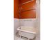 Bathroom features a clawfoot tub with chrome fixtures and stylish subway tile and orange paint at 145 Ryan Rd, Pittsboro, NC 27312