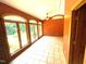 Bright sunroom, used as a bedroom, features tile floors, many windows, and access to the outside at 145 Ryan Rd, Pittsboro, NC 27312