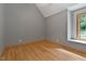 Neutral bedroom with hardwood floors, window view of lush greenery, and multiple outlets at 145 Ryan Rd, Pittsboro, NC 27312