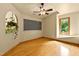 Cozy bedroom with hardwood floors, ceiling fan, and blackboard detail, plus bright window at 145 Ryan Rd, Pittsboro, NC 27312