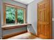 View of a naturally lit bedroom with a charming window seat and a classic wooden door at 145 Ryan Rd, Pittsboro, NC 27312