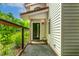 Modern entryway featuring stylish door, sidelight windows, and well-manicured landscaping at 145 Ryan Rd, Pittsboro, NC 27312