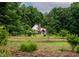 Charming home surrounded by lush greenery and expansive front yard, offering privacy at 145 Ryan Rd, Pittsboro, NC 27312