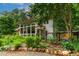 Exterior of house with a wall of windows and manicured plants at 145 Ryan Rd, Pittsboro, NC 27312