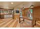 Open kitchen with stainless steel appliances, a dining table, brick accent wall and access to laundry room at 145 Ryan Rd, Pittsboro, NC 27312