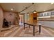 Eat-in kitchen with brick accent wall with fireplace, dining table, and white cabinets at 145 Ryan Rd, Pittsboro, NC 27312