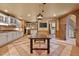 Spacious kitchen features a dining table, white cabinetry, and a brick accent wall at 145 Ryan Rd, Pittsboro, NC 27312