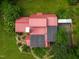 Aerial view of a red roof with solar panels set amongst lush greenery at 145 Ryan Rd, Pittsboro, NC 27312