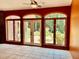 Bright sunroom featuring arched windows offering scenic garden views and tile flooring at 145 Ryan Rd, Pittsboro, NC 27312