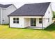 The backyard shows a covered patio with a sliding glass door and a neatly mowed lawn at 173 Little Creek Dr, Lillington, NC 27546
