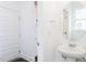 Clean powder room with a pedestal sink and oval mirror; features white door and trim at 173 Little Creek Dr, Lillington, NC 27546