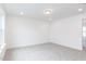 A bright bedroom with neutral carpet and white walls, and recessed lighting at 173 Little Creek Dr, Lillington, NC 27546