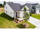 This lovely home shows a front yard featuring new landscaping and a two-car garage at 173 Little Creek Dr, Lillington, NC 27546
