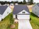 New construction home boasting a modern exterior, two-car garage, manicured lawn, and minimalist landscaping at 173 Little Creek Dr, Lillington, NC 27546