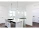 Open kitchen island with stainless steel dishwasher offering a view of a well-lit living room at 173 Little Creek Dr, Lillington, NC 27546