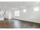 Inviting living room with hardwood floors, large windows, and open layout to the kitchen at 173 Little Creek Dr, Lillington, NC 27546