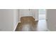 Inviting hallway with beautiful hardwood flooring, neutral walls, and entry to another room at 190 Babbling Creek Dr, Youngsville, NC 27596