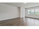 Spacious living room with wood-look floors and large windows with a backyard view at 190 Babbling Creek Dr, Youngsville, NC 27596