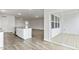 Open concept living space with wood-look floors, sliding glass door, and white walls at 190 Babbling Creek Dr, Youngsville, NC 27596