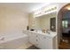 Bright bathroom features a soaking tub, dual sinks, and spacious vanity at 1911 Falls Landing Dr # 103, Raleigh, NC 27614
