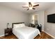 Comfortable bedroom features a ceiling fan, desk area, and a large window for natural light at 1911 Falls Landing Dr # 103, Raleigh, NC 27614