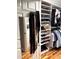 Organized walk-in closet with custom shelving, clothing racks, and wood flooring at 1911 Falls Landing Dr # 103, Raleigh, NC 27614