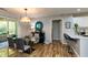 Dining area with modern glass table, stylish chairs, and sliding glass doors at 1911 Falls Landing Dr # 103, Raleigh, NC 27614